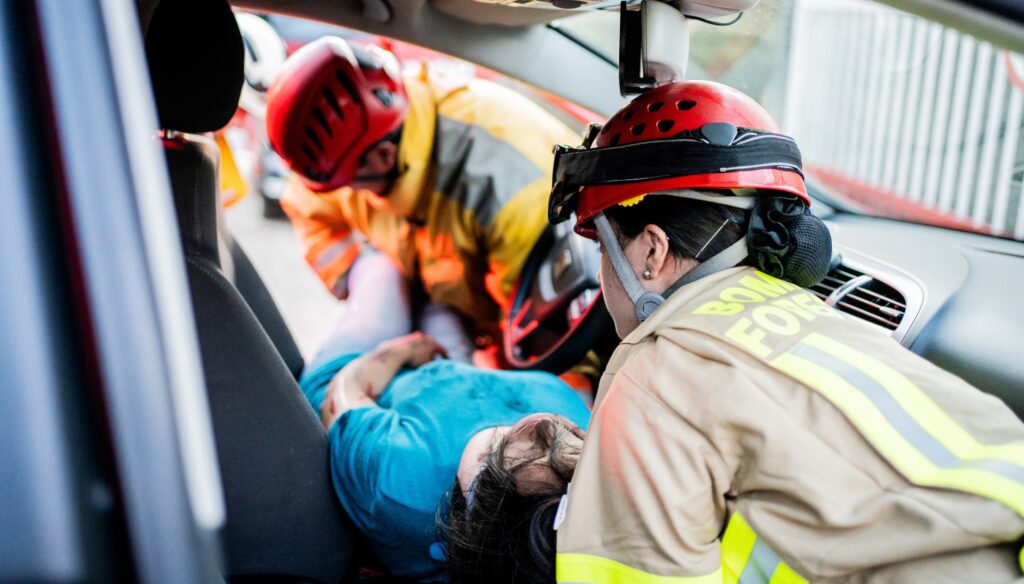 Firefighters helping a car accident victim